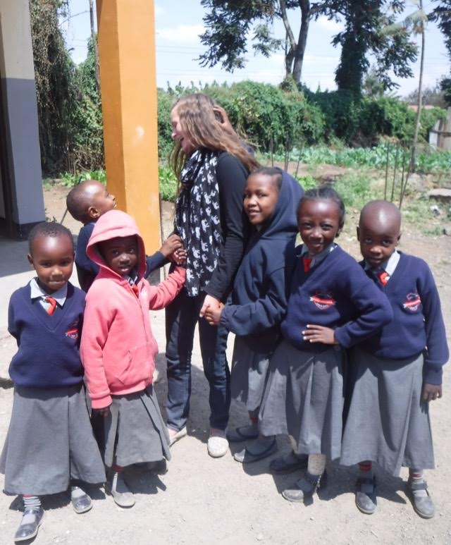 Zoe+Booth%2C+a+student+volunteer+from+the+United+States%2C+is+surrounded+by+smiling+school+girls+during+break+time+at+L.O.A.M.O.%2C+a+primary+school+in+Arusha%2C+Tanzania.+Many+of+these+children+live+a+hard+life+in+this+developing+country%2C+yet+they+continue+to+show+love+and+have+a+smile+on+their+faces.+