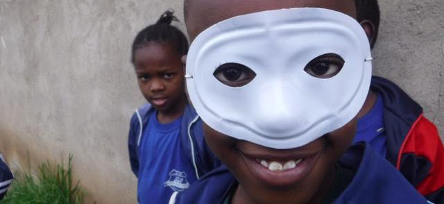 Calisty%2C+a+young+Tanzanian+boy%2C+wears+a+mask+while+playing+outside+in+his+schools+courtyard+after+classes.+Children+in+Tanzania+love+to+play+soccer%2C+sing+songs%2C+and+play+dress+up+as+fun+activities+after+school.+