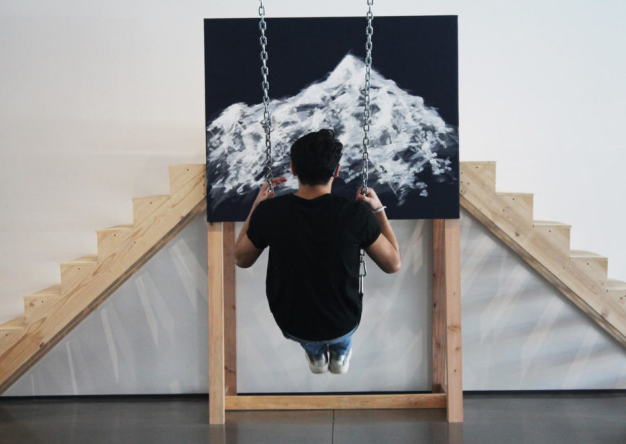 Adam Vasquez 19 swings on an interactive piece of art.