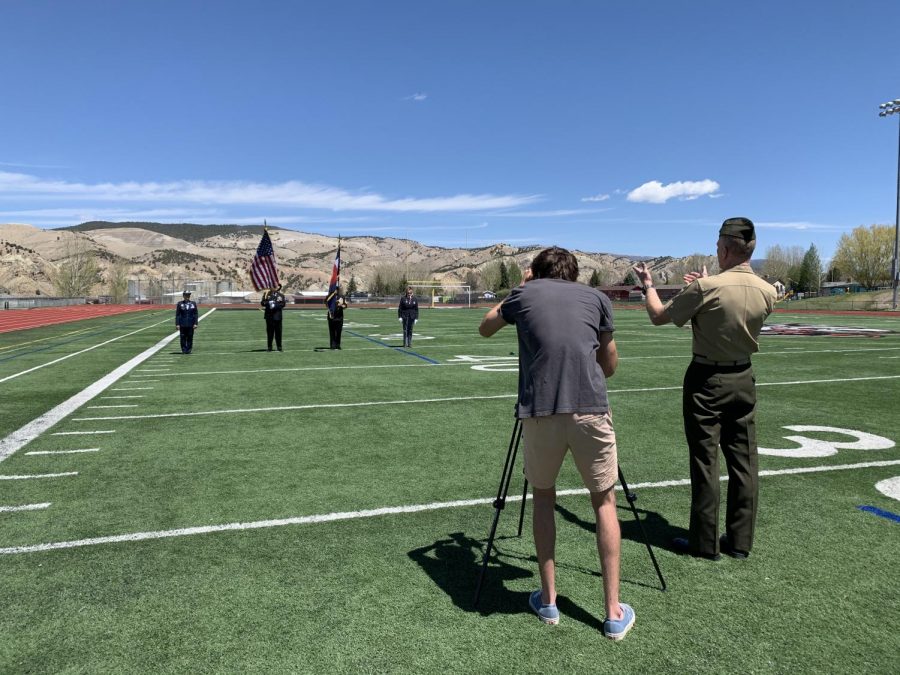Nate Felton 17 maintains social distance as he records video of the Minturn VFW performing the Presentation of Colors for the virtual graduation ceremony at Eagle Valley High School.