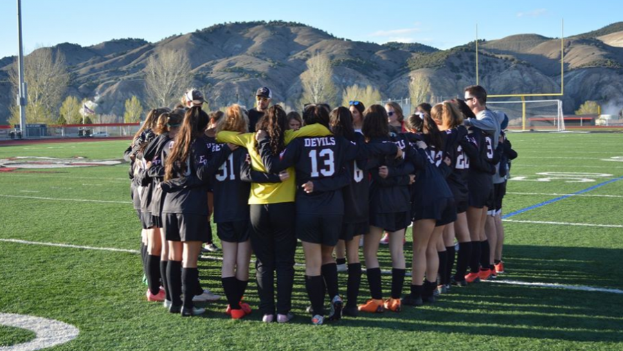 The Eagle Valley Girls Soccer team huddle before a game before the season was cancelled. 
I miss the atmosphere of a game and the excitement to get to showcase what we had been working on in practice, Coach Maggie Sherman says of the lost soccer season. 