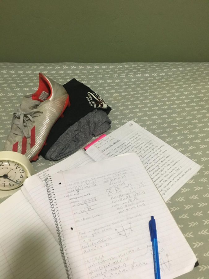 This photo captures student life by demonstrating the workload students have in their day to day schedule. The papers, cleat, and clock all act as symbols to represent the academic and athletic side of time management. All the items are placed on a bed which also alludes to the need for rest and management of mental health.