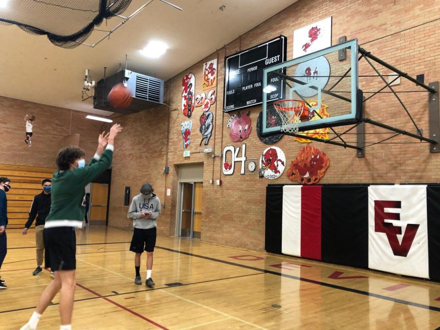 Students practice shooting at pre-season training for basketball.